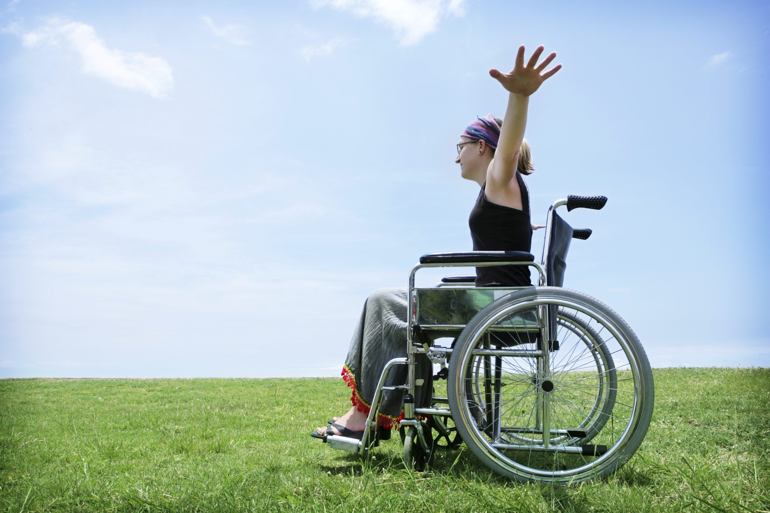 woman on wheelchair with outstretched arms
